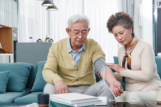 The elderly couple measuring blood pressure