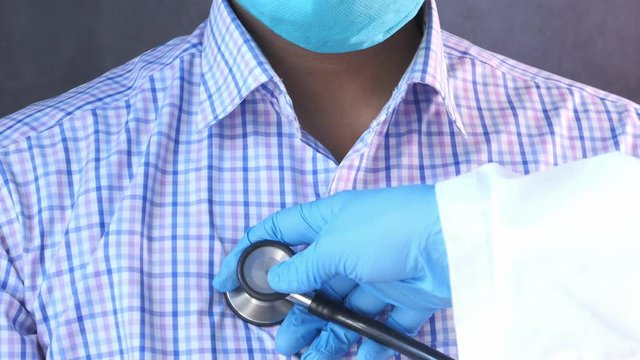 Doctor using a stethoscope checking body, close up