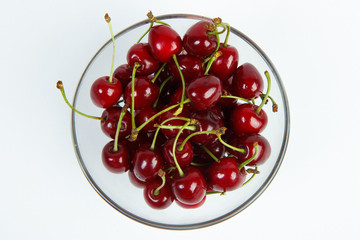 
cherries in a bowl on a white background