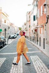 Fototapeta premium Young body positive woman crossing street in city