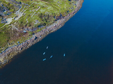 Aerial view of people surfing along bank of&Ocirc;&oslash;&Omega;Teriberka River