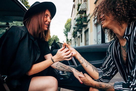 Loving man with engagement ring proposing his girlfriend sitting in car - Powered by Adobe