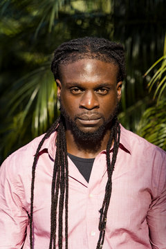 Close-up of serious young man with dreadlocks