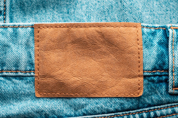 branded patch without text on jtns. jeans close-up. leather patch jeans