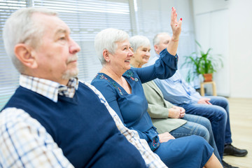 Senior citizens participating in group event in retirement home