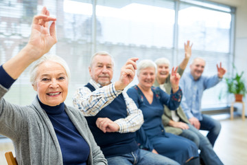 Senior citizens participating in group event in retirement home