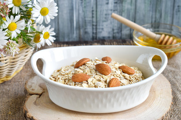 Oatmeal with almonds in a bowl close-up.
