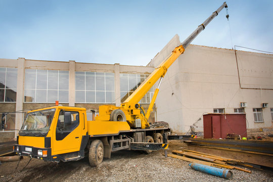 Big Power Mobile Crane on a road and tower crane in construction site