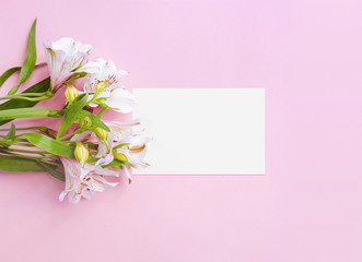 Business card on pink pastel background decorated with white flowers bouquet. Business woman template. Mock up. Space for text. Place for text. Flatlay. High quality photo