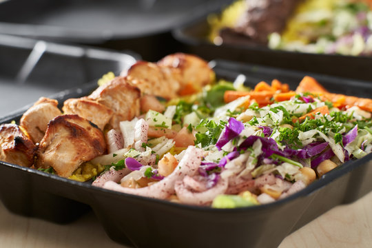 greek chicken souvlaki take out container with rice and pickled vegetables