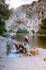 couple on the beach by the river in the Ardeche France Pont d Arc, Ardeche France,view of Narural...