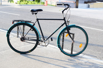 Fototapeta na wymiar Green city bike on street, pedal, bicycle