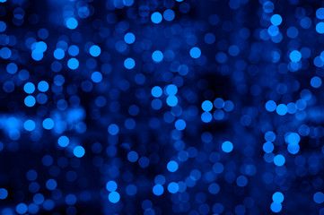 blurred glowing lights of garlands of classic blue color, bokeh