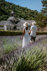 couple visit the old town of Gordes Provence,Blooming purple lavender fields at Senanque monastery,...