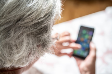 An elder lady using a smartphone