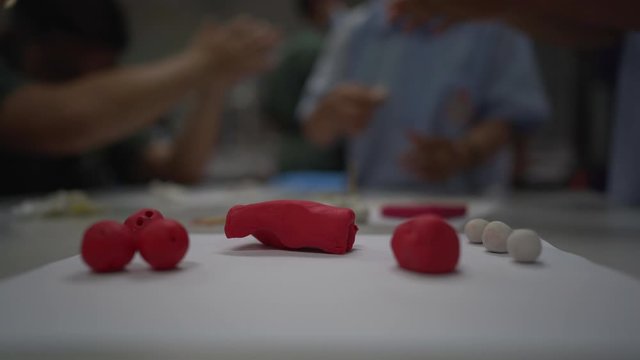 
Close up hand use molding plasticine to isomer molecule of chemistry substance in classroom  