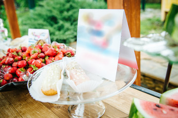 various cakes and promotional cards on a platter