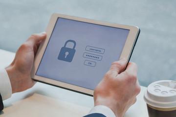 user typing login and password on digital tablet computer, data protection and internet security...
