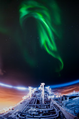 Obraz na płótnie Canvas Aurora borealis and LNG vessel at the night