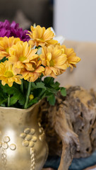Apartment interior with flowers. Chrysanthemum flowers in a vase on a marble table.