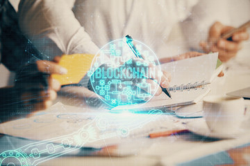 Double exposure of blockchain theme drawing over people taking notes background. Concept of...