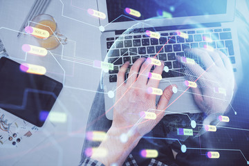 Multi exposure of man's hands typing over computer keyboard and world map hologram drawing. Top view. Technology concept.