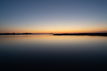 Fototapeta premium Long exposure summer sunset over lake in Sweden.