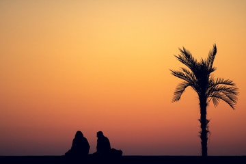 silhouette of a woman on a sunset background