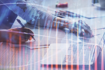 Double exposure of businesswoman hands typing on computer and forex chart hologram drawing. Financial analysis concept.