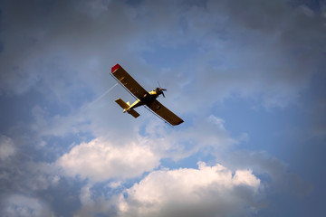 the airplane flying in the clouds in the beautiful sky