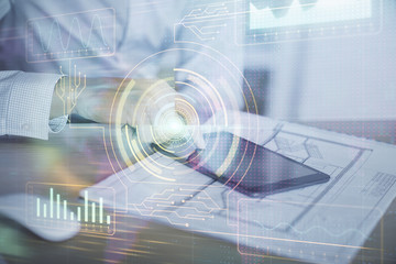 Obraz premium Double exposure of man's hand holding and using a digital device and data theme hologram drawing. Technology concept.