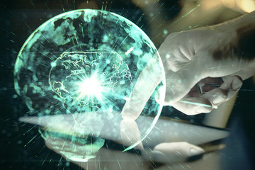 Double exposure of man's hands holding and using a phone and international business theme drawing.