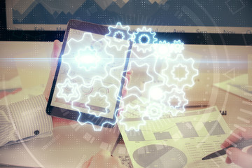 Double exposure of man's hands holding and using a phone and international business theme drawing.