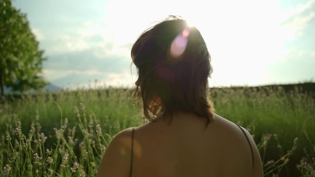 smelling a lavender flower in the afternoon in a field in Spain