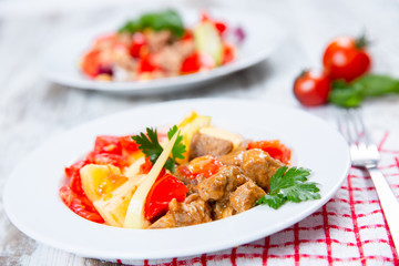 cooked meat with tomatoes and potatoes