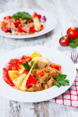 cooked meat with tomatoes and potatoes