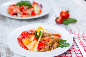 cooked meat with tomatoes and potatoes