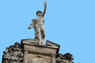 Fototapeta na wymiar Statue of Mercury on a building facade in city Lviv, Ukraine
