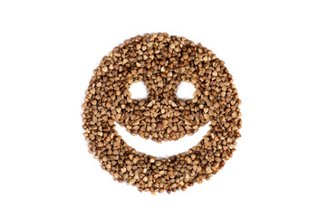 isolated smiley icon with eyes and a sad smile, made from raw buckwheat. Sad face of buckwheat on a white background