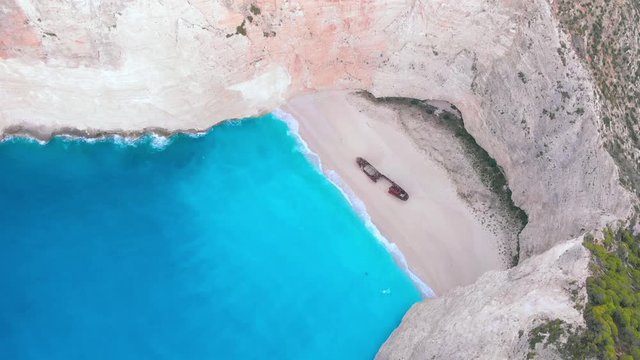 Aerial panorama landscape 4K shot of navagio crystal water shipwreck beach in Zakynthos Greece 