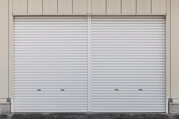 Automatic silver roller shutter doors on the ground floor of the house