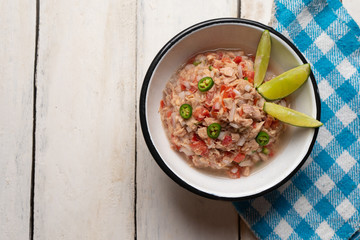 Canned tuna ceviche with chili pepper and tomato on white background