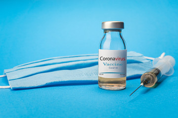 Obraz premium Coronavirus vaccine concept and background. New vaccine sputnik-v isolated on blue background. Covid-19, 2019-nCov pandemic.