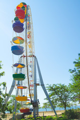 Ferris wheel in the amusement park against the background of the sky. Crimea settlement Mezhvdnoe