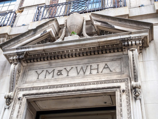 engraved YM and YW Hebrew Association entrance front sign above door