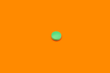 Green pill on orange background. Light green pill on yellow background. Orange seamless pattern and green pill.
