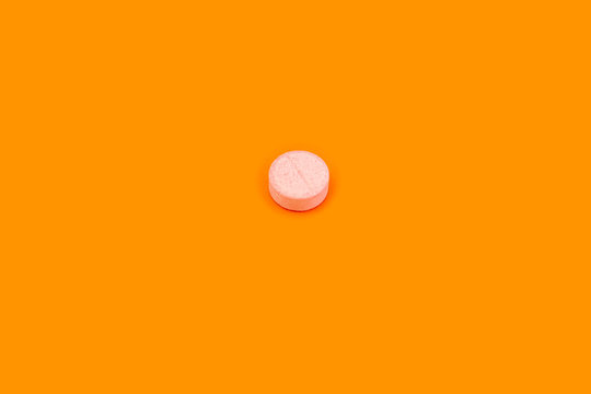 Pink Pill On Orange Background. Red Pill On Yellow Background. Orange Seamless Pattern And Pink Pill.