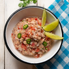 Canned tuna ceviche with chili pepper and tomato on white background