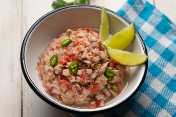 Canned tuna ceviche with chili pepper and tomato on white background