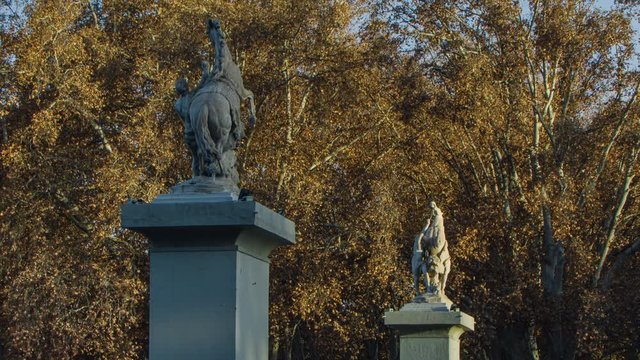 Time lapse of the sun going down over the Marly horses, a set of sculptures set at the entrance of the city park. 